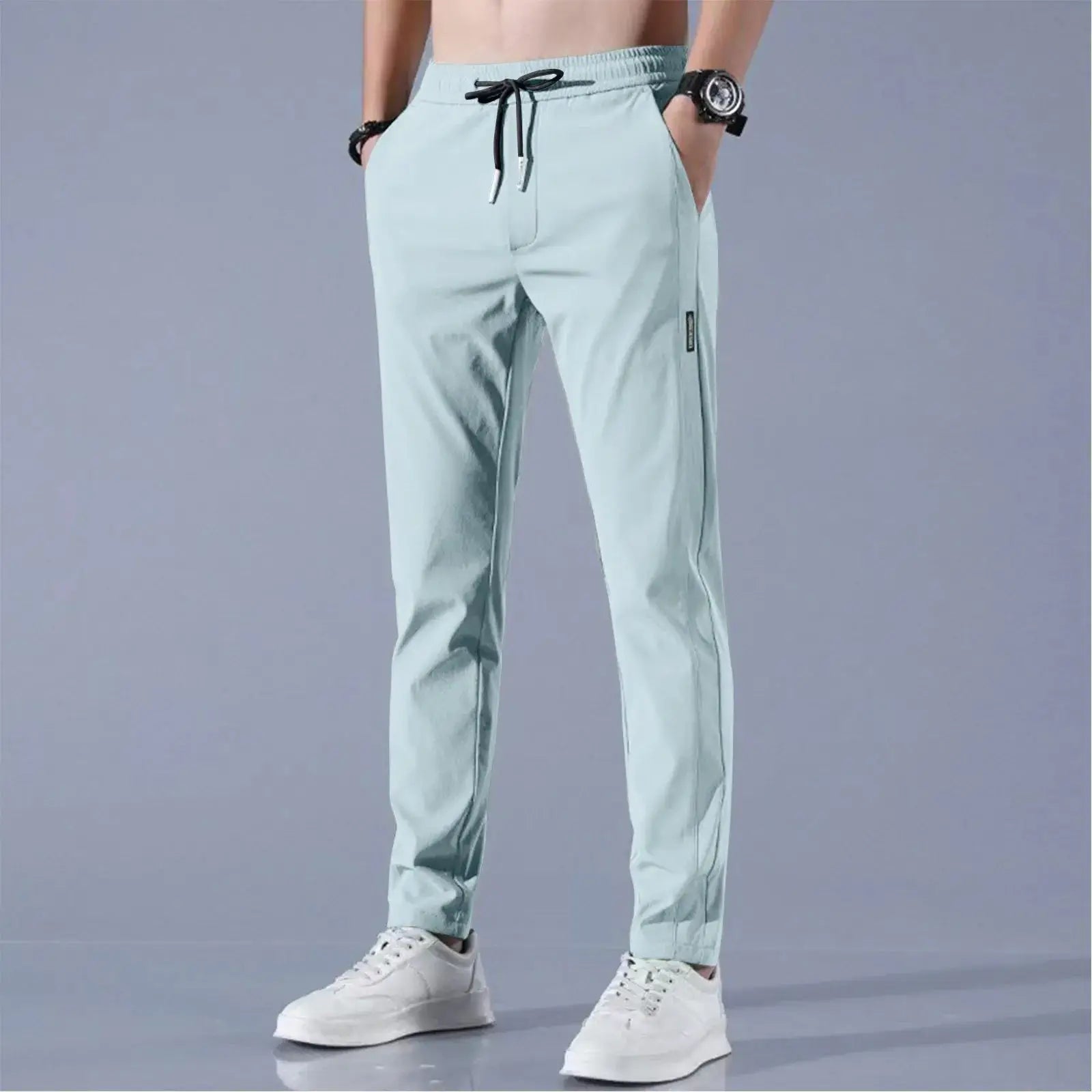 Mint green men’s quick-dry stretch pants featuring breathable ice silk fabric, mid-waist loose fit and straight-leg design for summer style.