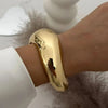 Gold vintage wide bracelet on wrist