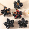 Black flower hair clips with colorful accents