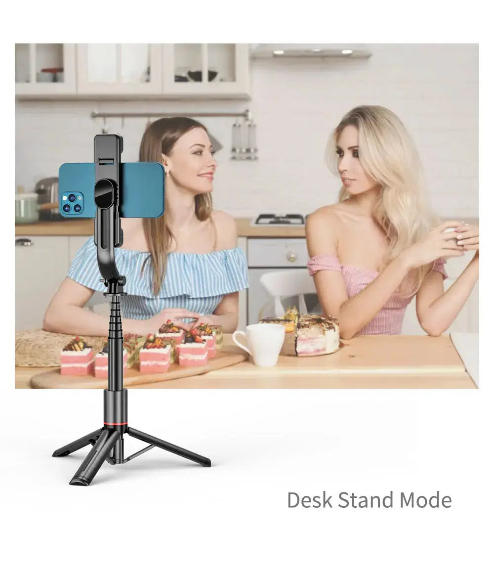 Selfie Stick Tripod with Fill Light in desk stand mode, used for filming two women in a kitchen setting, ideal for content creators.