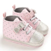 Pink polka dot baby sneakers with silver toe