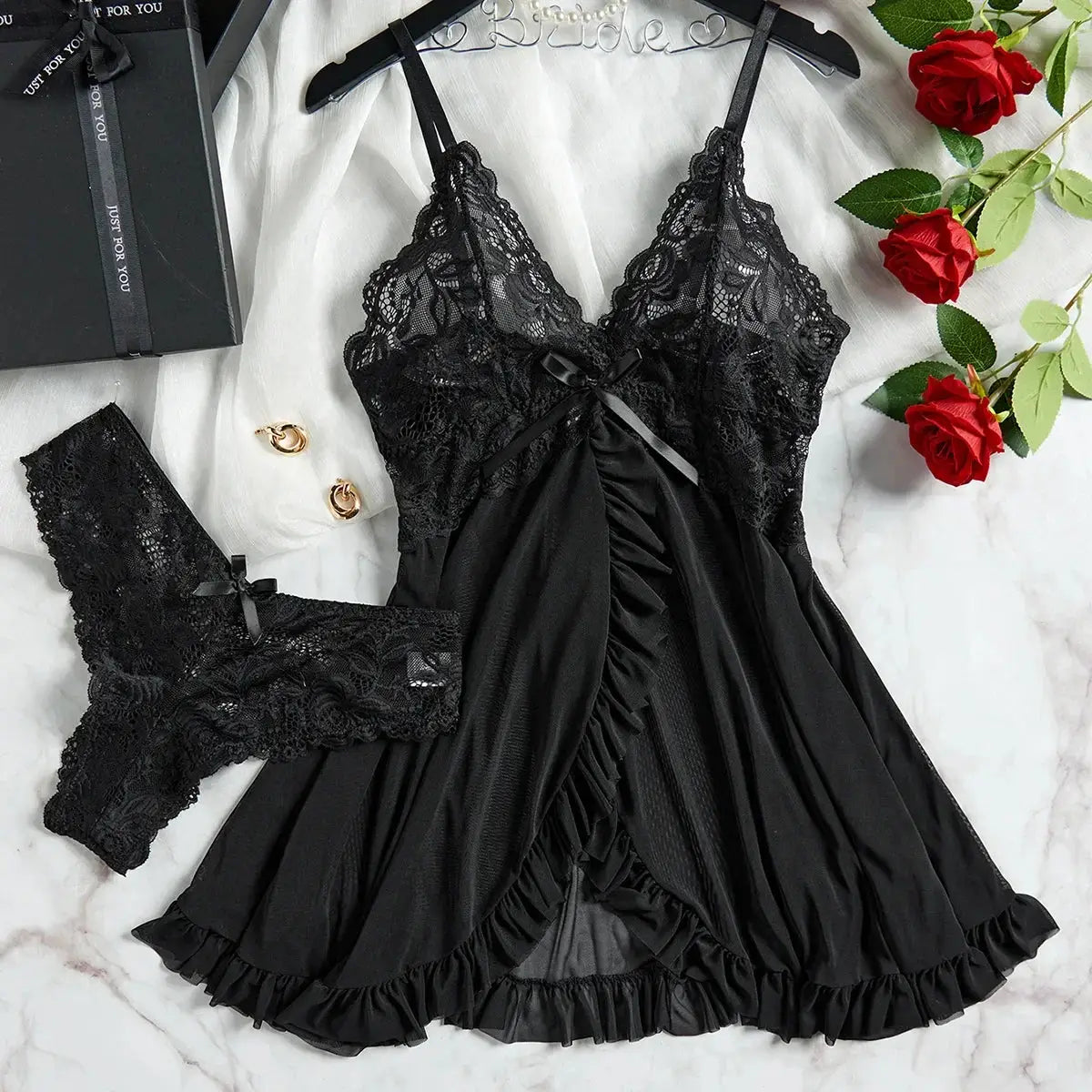 Black lace V-neck sleepwear set with ruffled hem and matching lace panties, featuring adjustable straps for a custom fit.