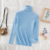 Light blue women's turtleneck sweater on bed