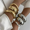 Gold and silver vintage wide bracelets on wrist