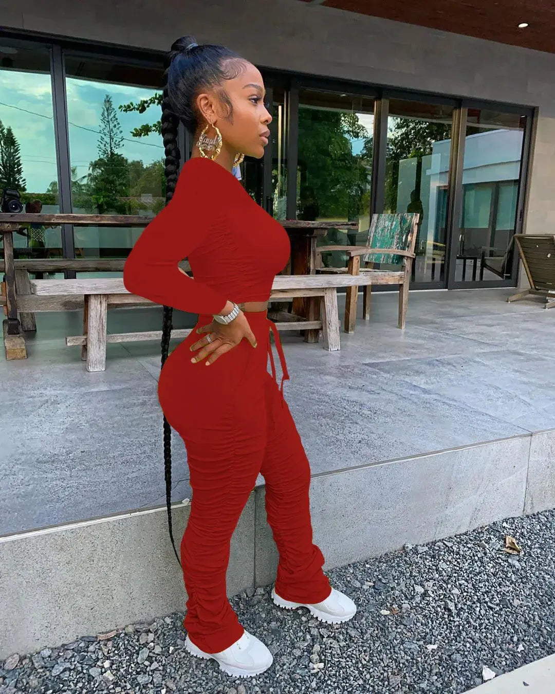 Red Women’s Autumn Two-Piece Sportswear Set worn outdoors, featuring stacked pants and a long sleeve crop top for a trendy fall outfit.