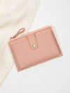 Minimalist short wallet in soft pink on white fabric