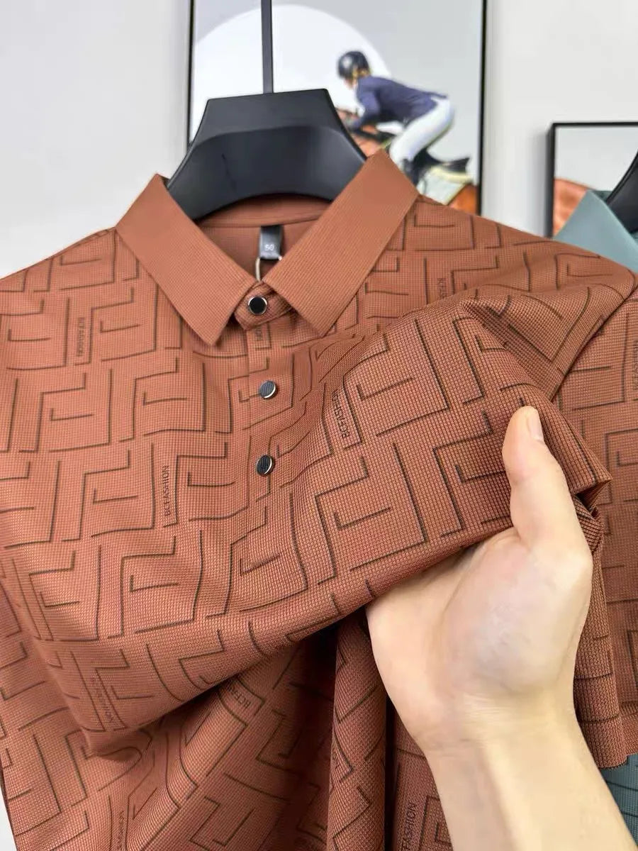 Rust orange silk t-shirt for men with geometric pattern held close-up.