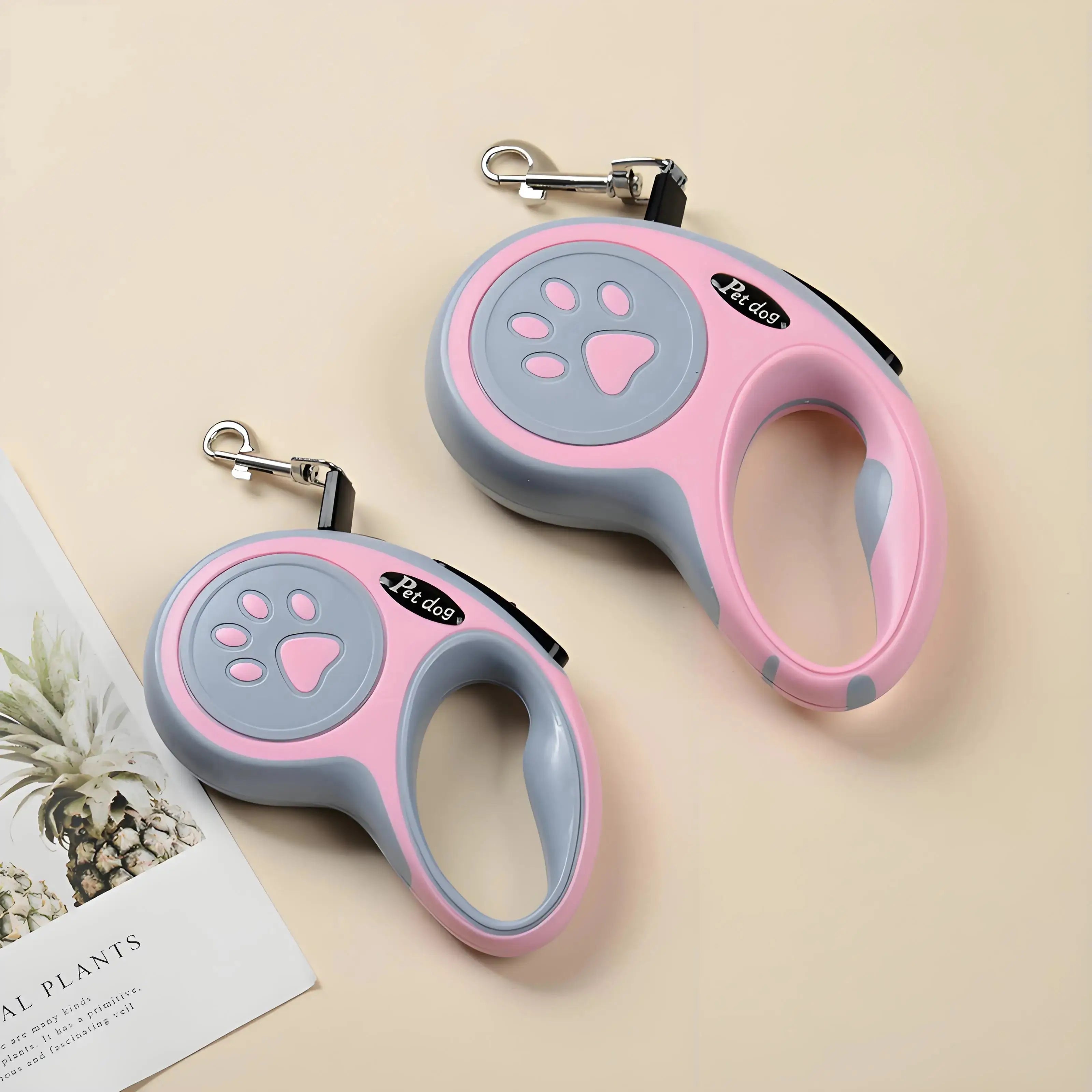 Two pink Automatic Retractable Nylon Pet Leashes with ergonomic handles. Perfect for walking and running small dogs and cats with secure traction rope.
