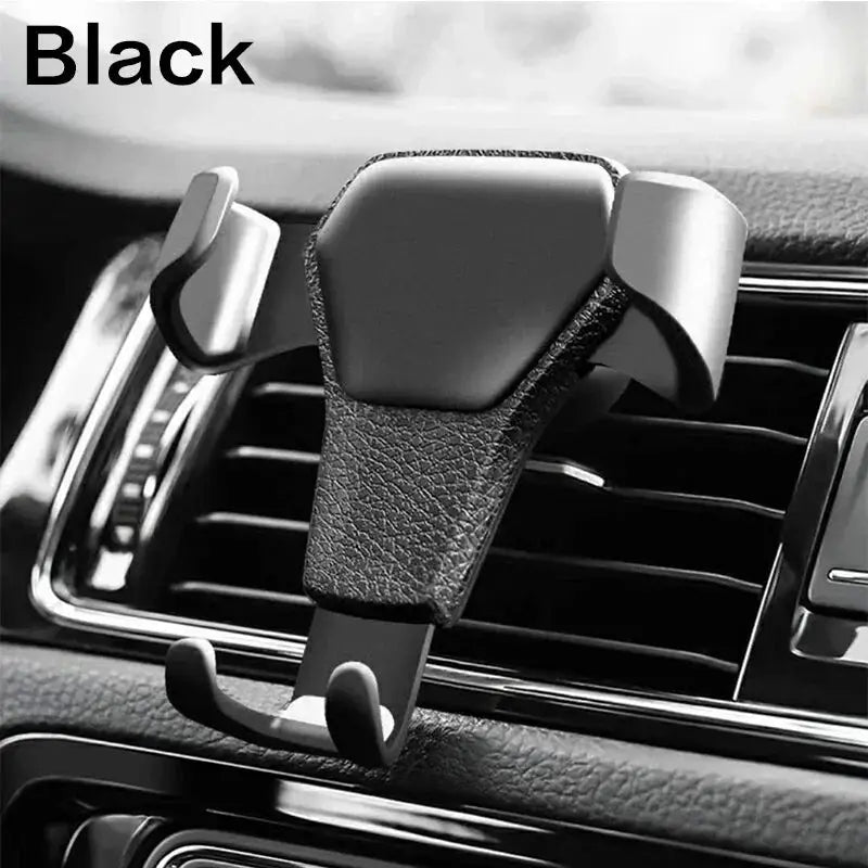 Black universal gravity phone holder with leather-textured finish, mounted on car air vent for hands-free smartphone use.