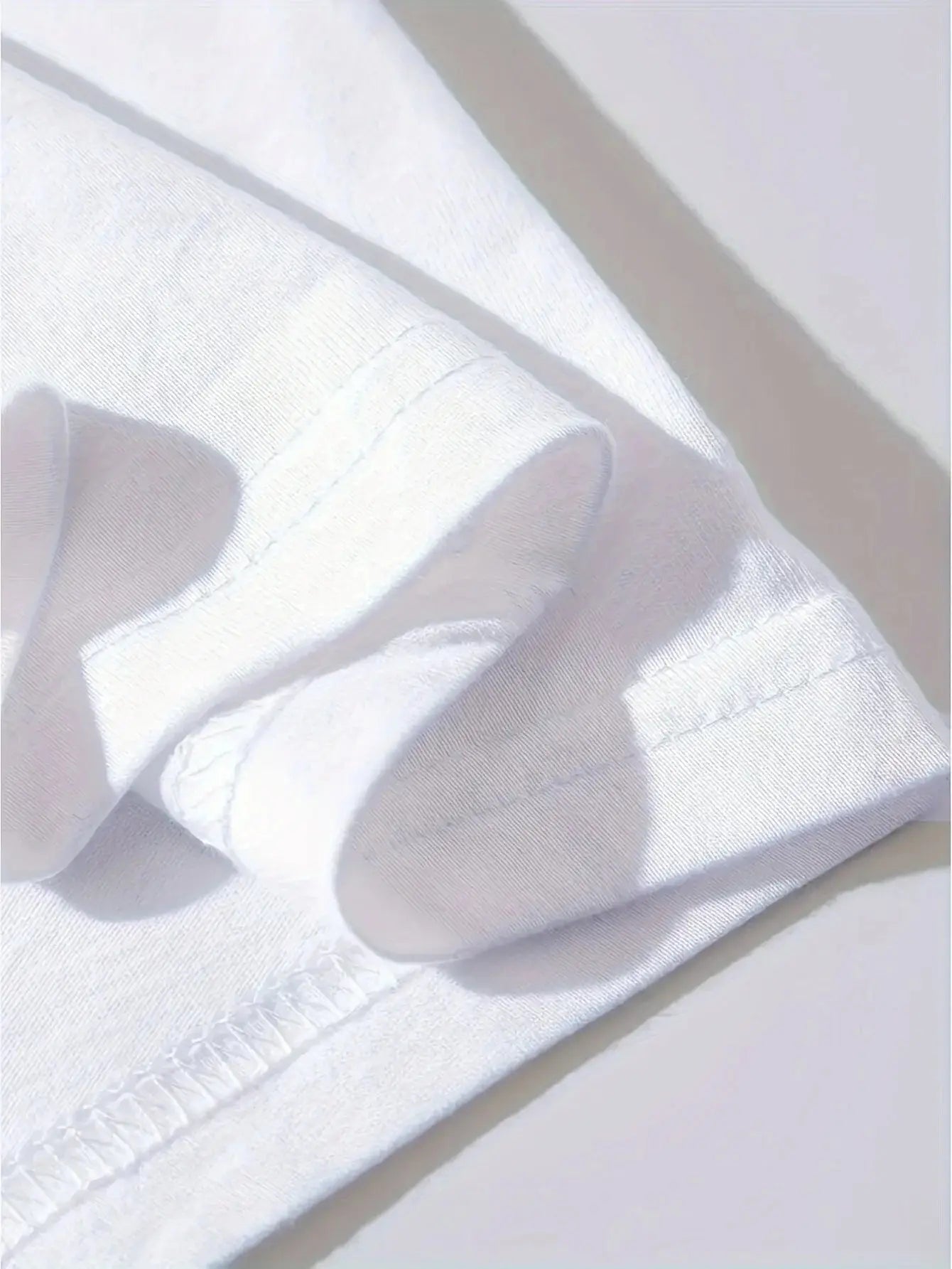 Detailed view of sleeve stitching on Men’s Cross Print T-Shirt 100% Cotton, emphasizing high-quality craftsmanship and comfort.