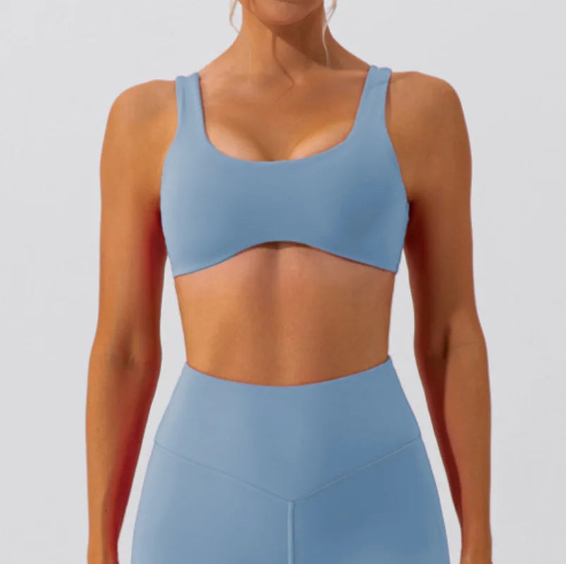 Blue slim fit yoga bra, front view, paired with matching leggings.