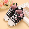 Black baby sneakers with pink bow