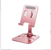 Pink foldable phone desk stand on white background