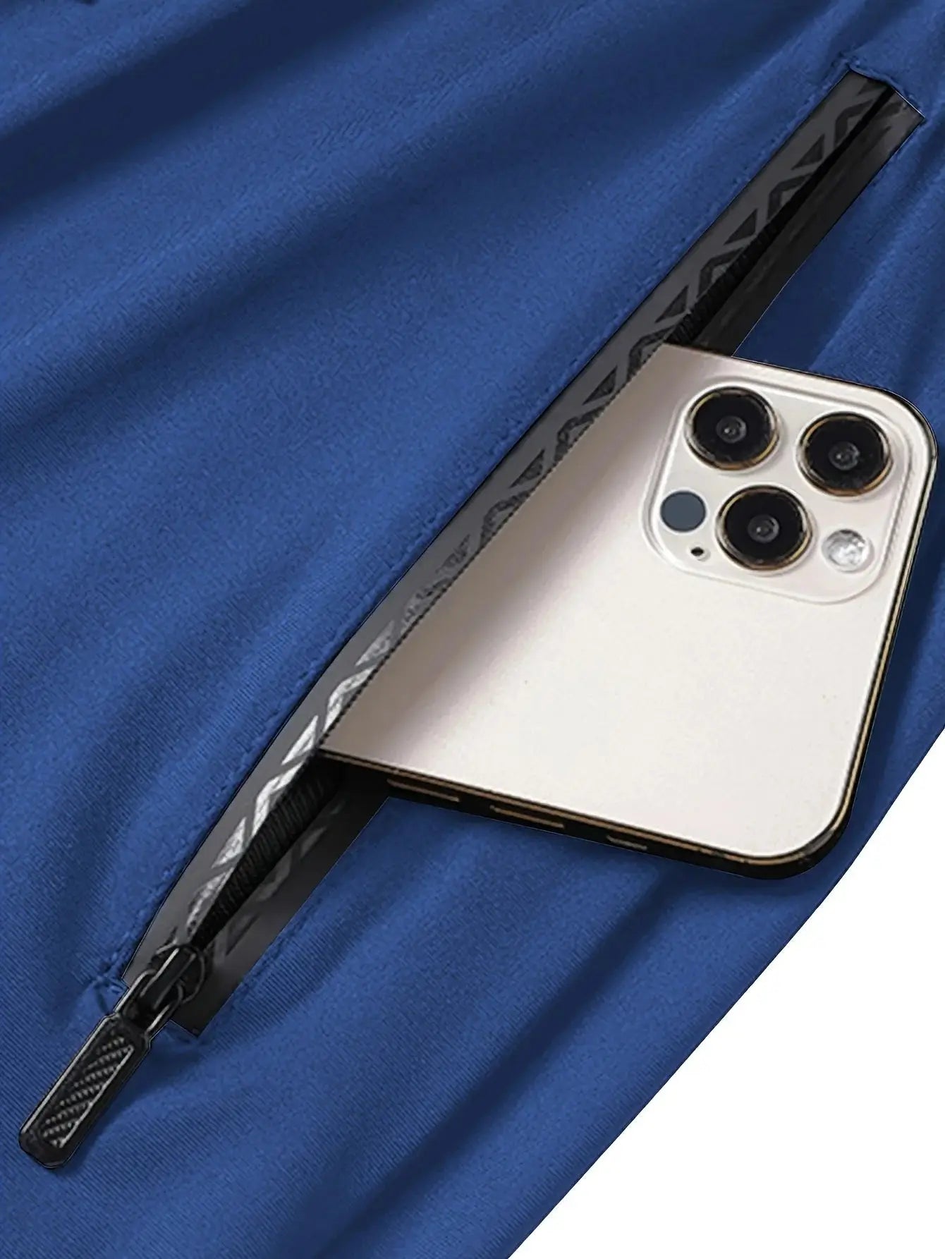 Close-up of blue Mens Quick-Dry Training Pants zipper pocket securely holding a smartphone, showcasing functional activewear design.