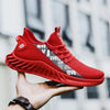 Red mesh breathable casual sports shoes held in hand