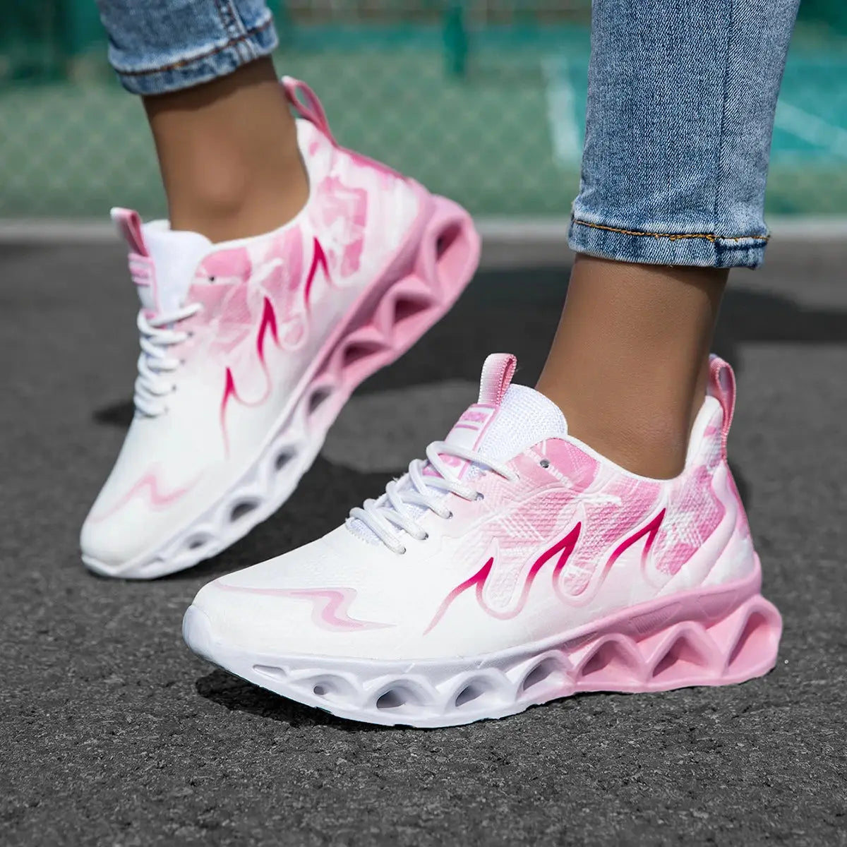 Flat casual women's sneakers with pink accents, breathable upper, and lightweight blade sole for jogging or everyday wear.