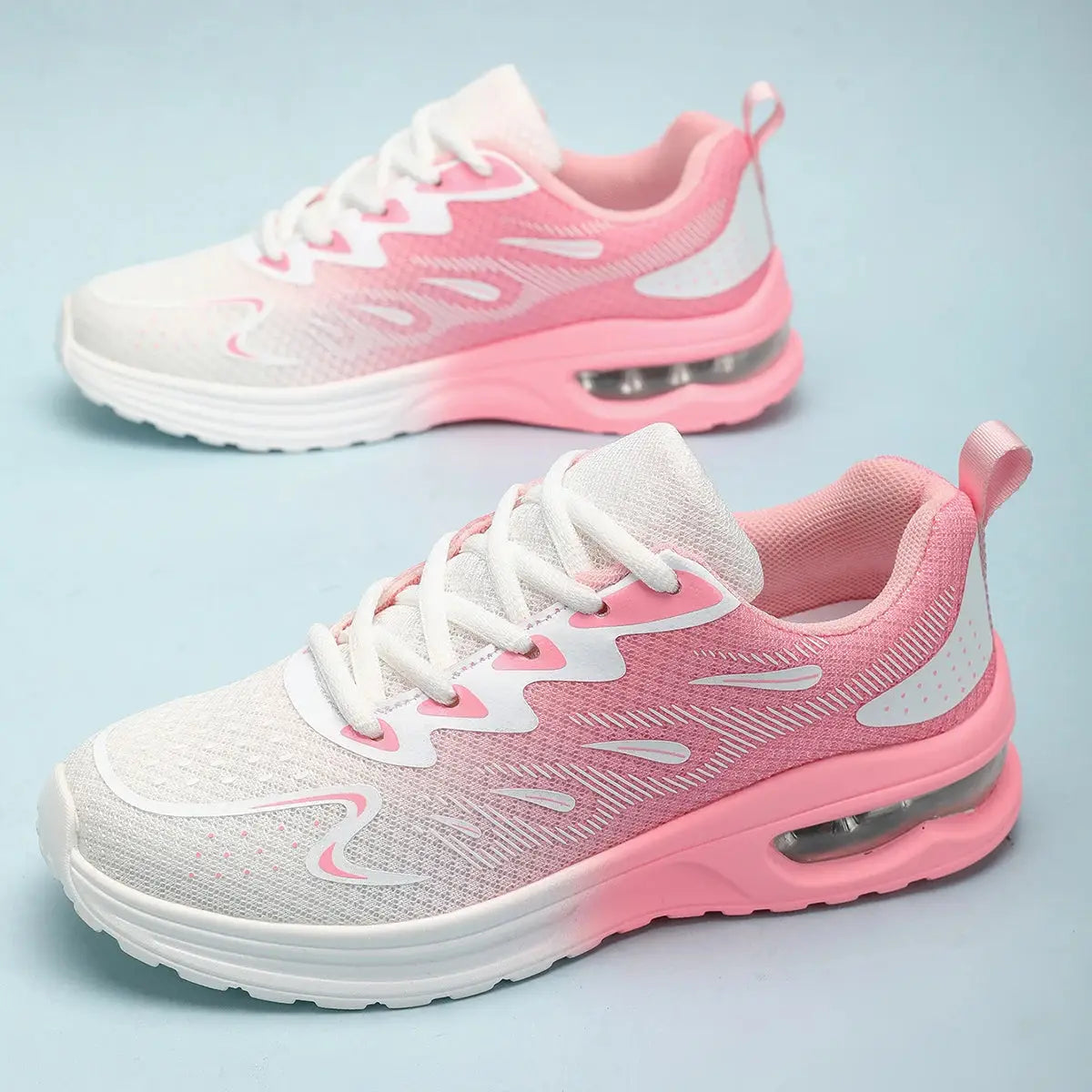Pink and white walking sneakers for women with breathable mesh and air-cushioned sole, perfect for casual or athletic wear.