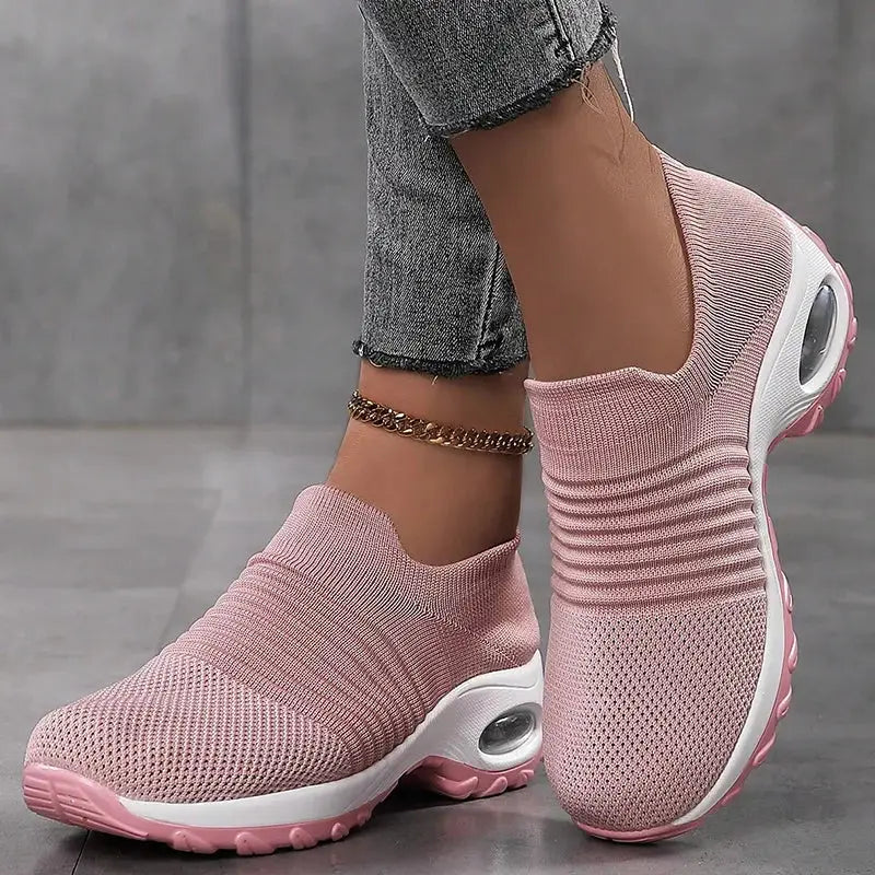 Pink women's slip-on sock sneakers with white air cushion sole, breathable mesh upper for walking, casual wear or fitness training.