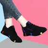 Women's black vulcanized shoes featuring vibrant color highlights