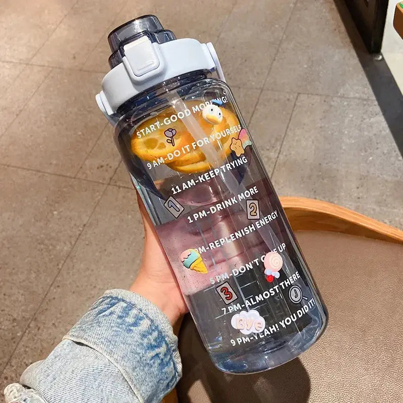Blue 2L water bottle with straw and motivational time markers, citrus infuser, and colorful stickers for fitness and summer hydration.