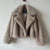 Light brown luxury fur coat on hanger