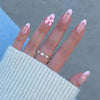 Pink French nails with delicate bow accents