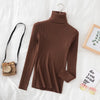 Brown women's turtleneck sweater on bed