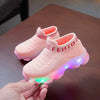 Pink children's sports shoes with LED light-up soles