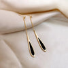 Elegant black and gold teardrop dangle earrings