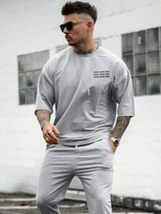 Gray cotton t-shirt for men with 'Faith Over Fear' text, paired with matching joggers.