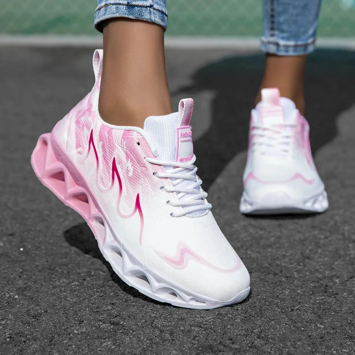 Women's running sneakers with pink flame design, breathable mesh upper, and soft pink blade sole for jogging or casual wear.