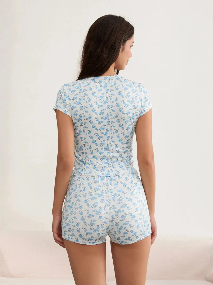 Back view of women’s 2-piece floral outfit in light blue, showing fitted crop top and high-waist shorts, perfect for summer lounging.