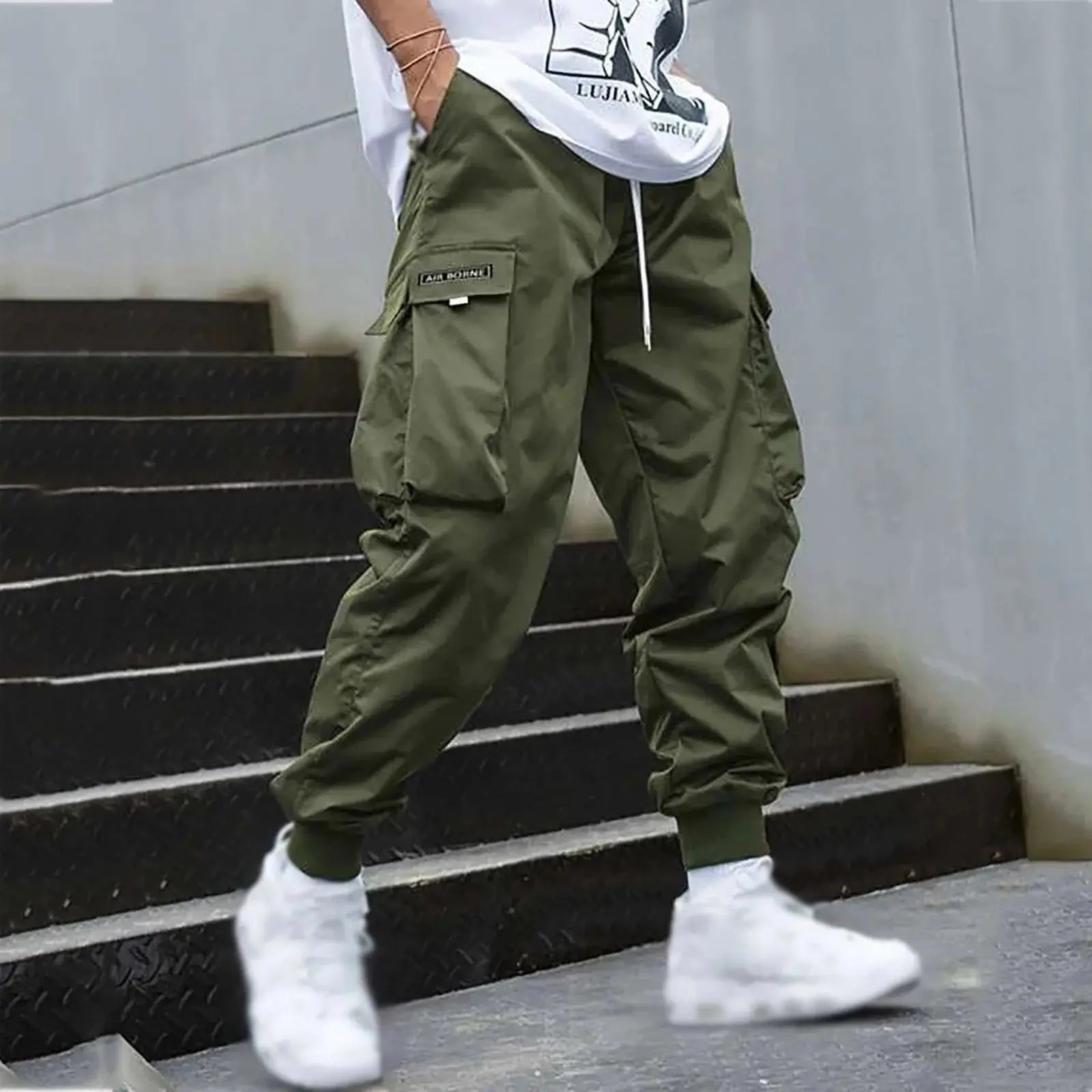 Olive green men’s cargo jogger pants with drawstring waist and side pockets, perfect for casual streetwear or travel outfits.