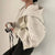 Beige women's fashion zipper hoodie sweatshirt, side view