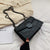 Black vintage rivet chain shoulder bag on fabric