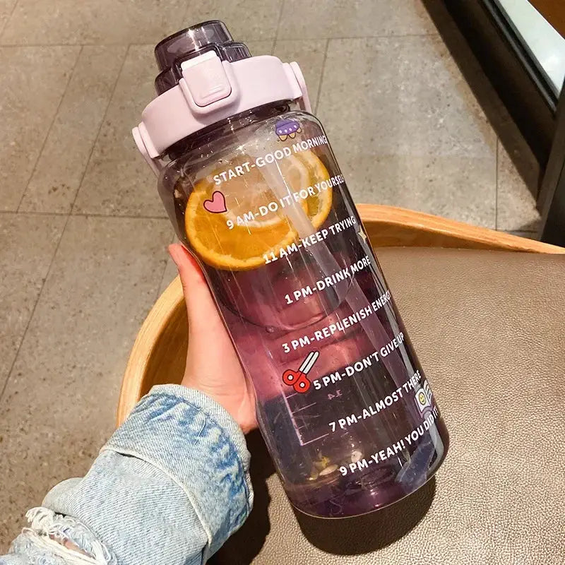 Purple 2L hydration jug with straw, time marker, and fruit infuser, featuring scissors and heart stickers for fun and functional water tracking.