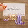 Gold earring set with purple and pearls