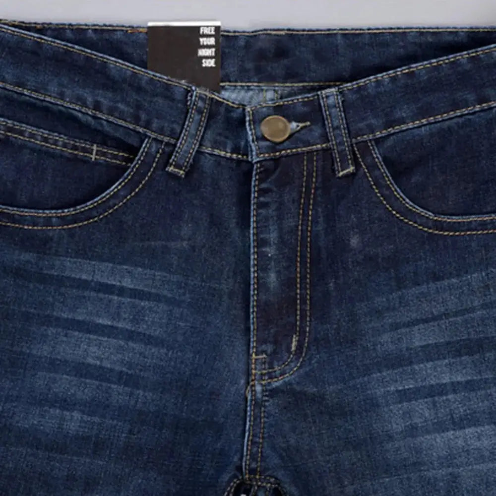 Close-up of front waist and pocket design on men’s stretch denim jeans with zipper fly and contrast stitching.