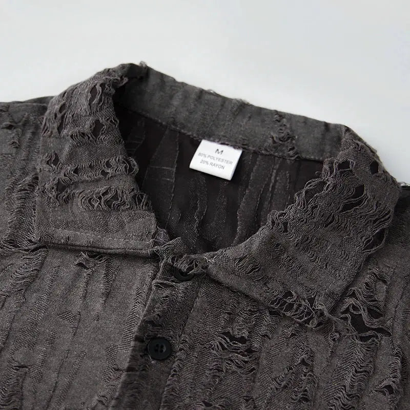 Close-up of collar and buttoned V-neck on men’s short sleeve T-shirt with distressed texture, ideal for casual summer outfits.