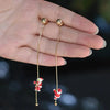 Santa-themed asymmetrical dangle earrings