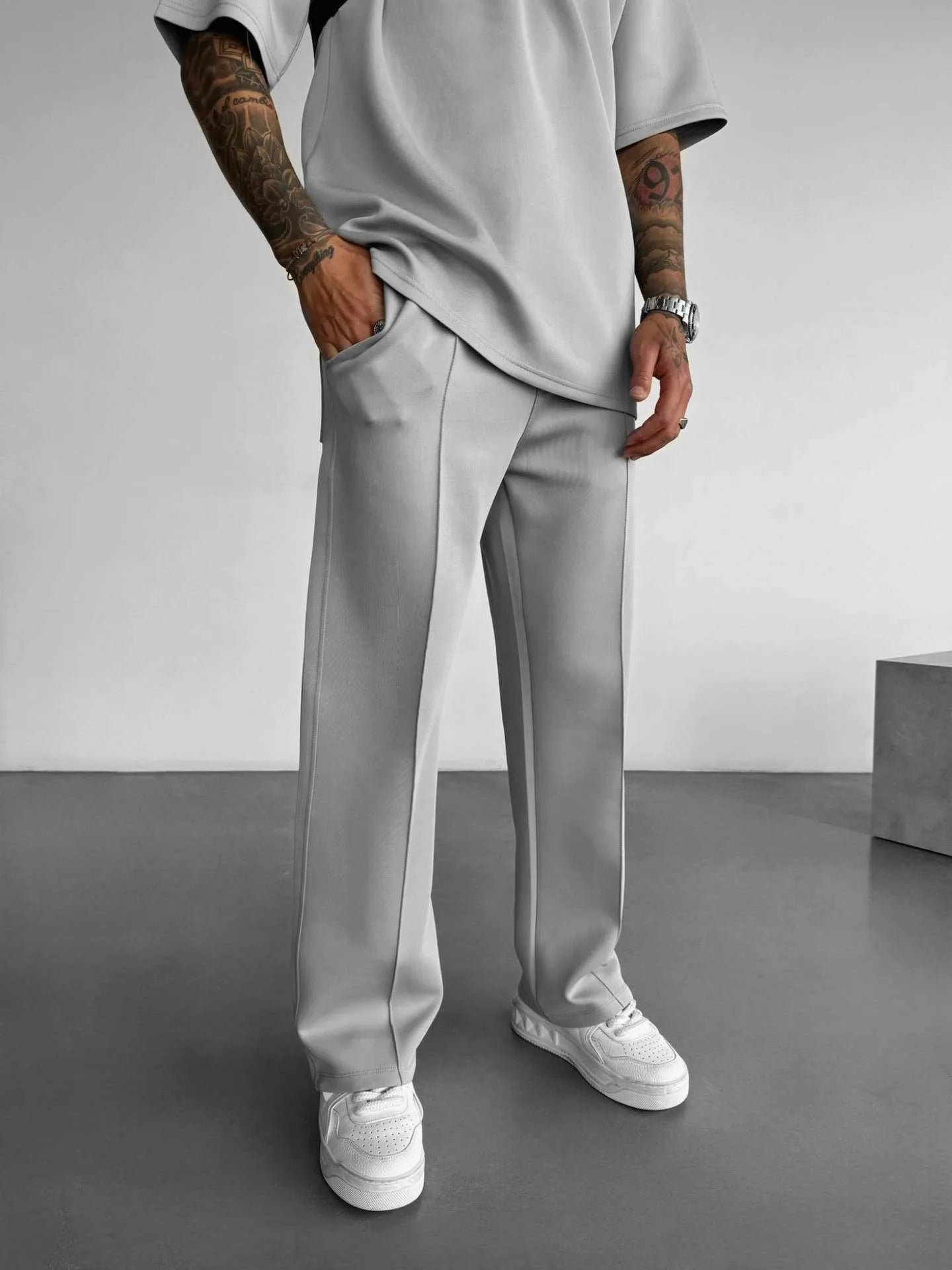 Gray men's casual pants with elastic waist and stylish straight fit.