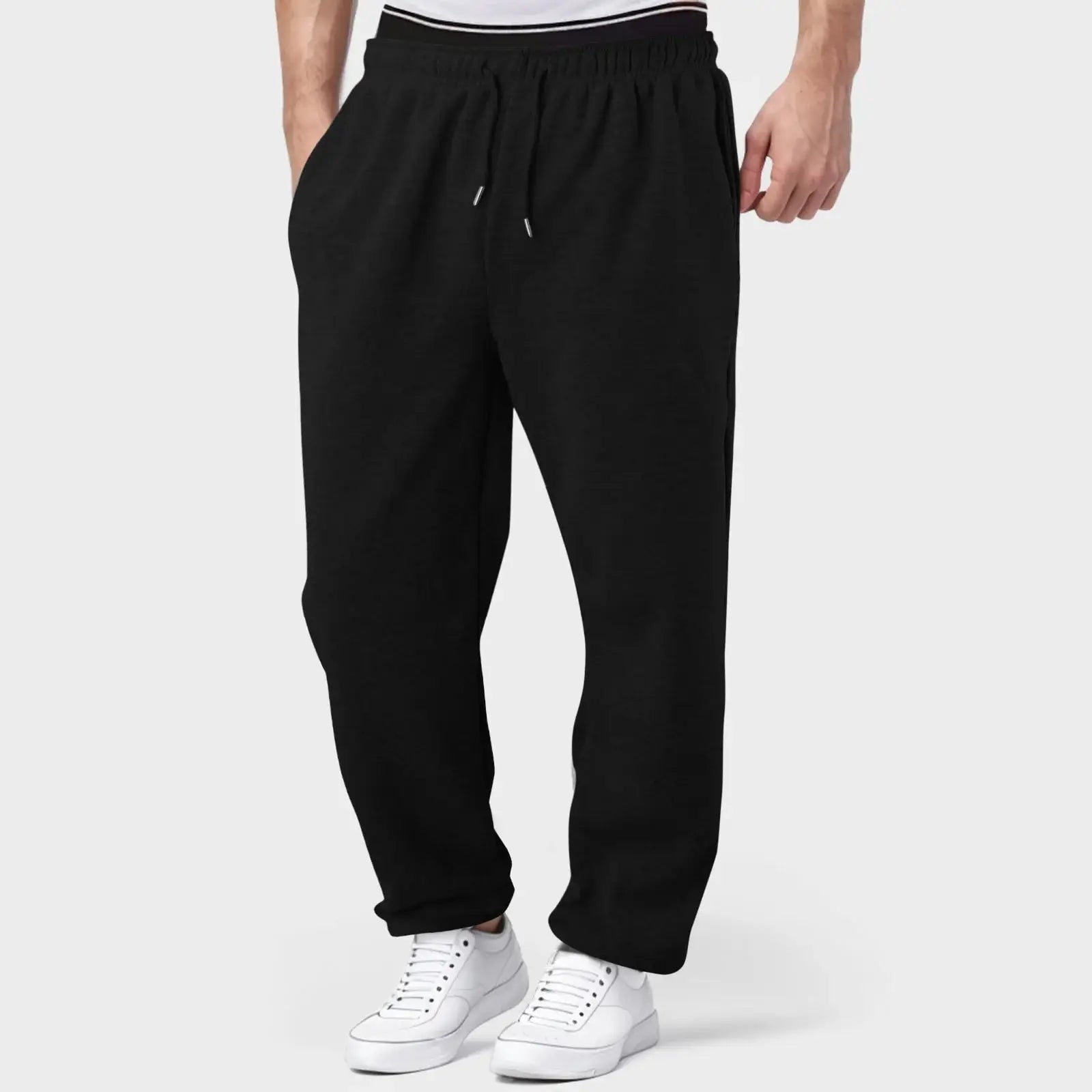 Men’s black jogger pants with elastic waistband, designed for comfort and flexibility during fitness and casual activities.
