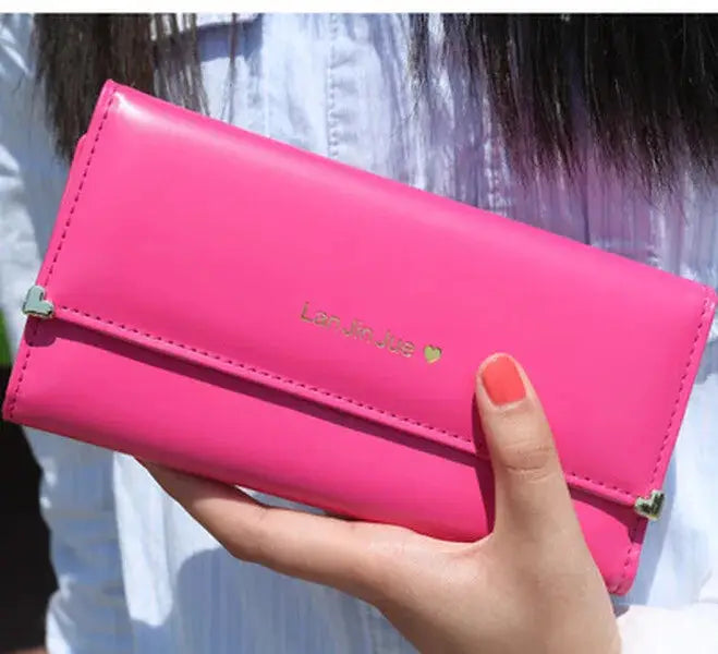 Hot pink Women's Long PU Leather Trifold Wallet with heart clasp, offering vibrant color and practical storage for daily essentials.