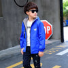 Child wearing blue waterproof jacket outdoors