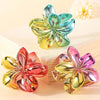 Metallic flower hair clips in blue, pink, and gold