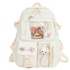 White backpack with bear and rainbow decorations