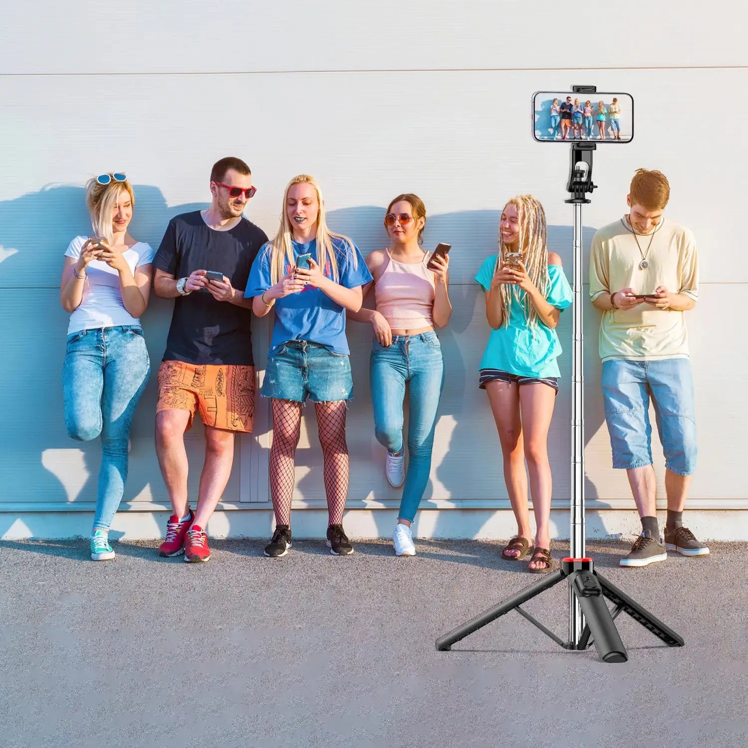 Bluetooth Selfie Stick Tripod in tripod mode capturing group photo, ideal for social media content creation and mobile photography.