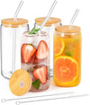 Glass tumblers with bamboo lids, straws, and fruit drinks