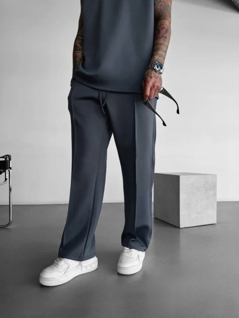 Dark gray men's casual pants with elastic waist and modern style.