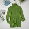 Green women's turtleneck sweater on hanger